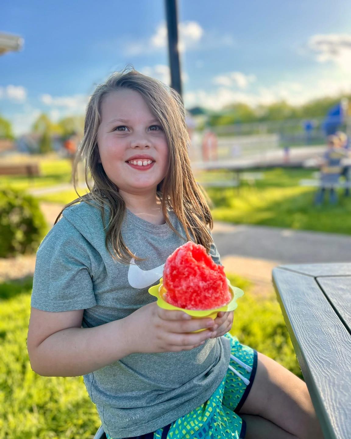Smiling girl with red shaved ice