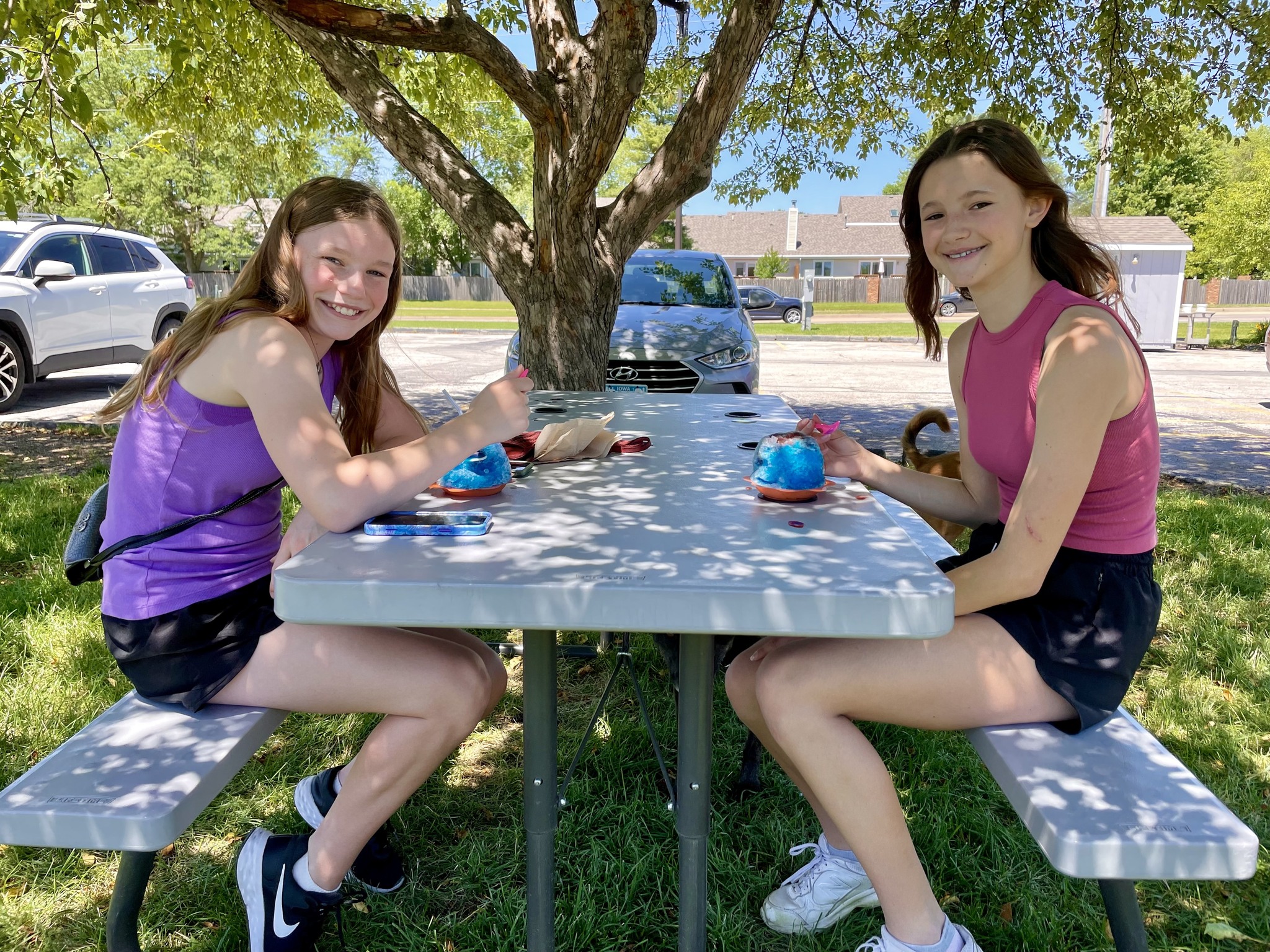 Two girls at a picnic table