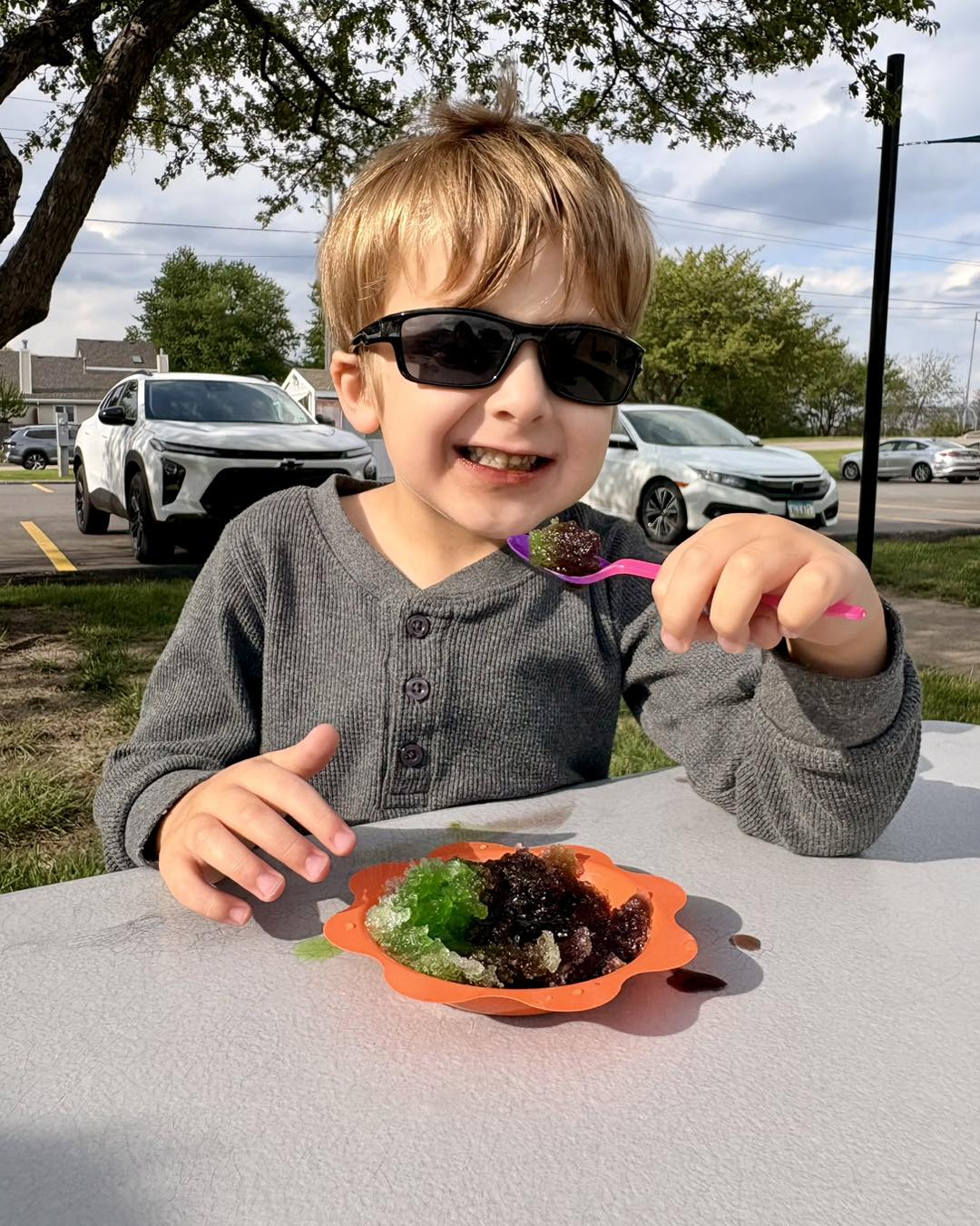 Boy in sunglasses with shaved ice